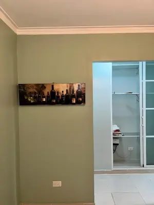 a wall with a painting of wine bottles on it at Tranquilo Apartamento de 3 habitaciones in Los Paredones