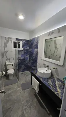 a bathroom with a sink and a toilet at Villa Victoria in Sosúa