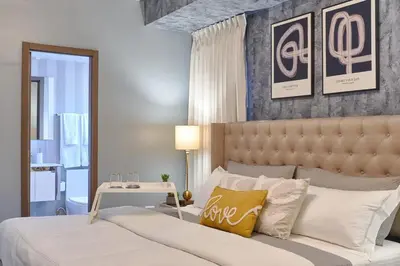 a bedroom with a large bed and a table at Modern Comfort Apartment at Bella Vista in Santo Domingo