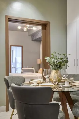 a dining room with a table and chairs and a bed at Modern Comfort Apartment at Bella Vista in Santo Domingo
