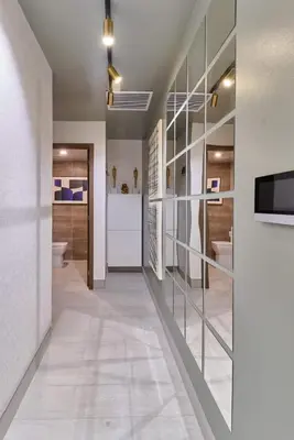 a bathroom with a hallway with glass partitioning at Modern Comfort Apartment at Bella Vista in Santo Domingo