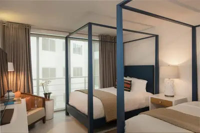 a bedroom with two beds and a canopy bed at The Ocean Club, a Luxury Collection Resort, Costa Norte in Sosúa
