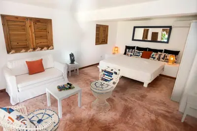 a living room with a bed and a couch at Villa Ibiscus in Las Galeras