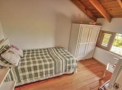a bedroom with a bed with a plaid blanket at Villa Ibiscus in Las Galeras