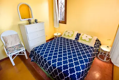 a bedroom with a blue bed and a white dresser at Villa Caribeña in Las Galeras
