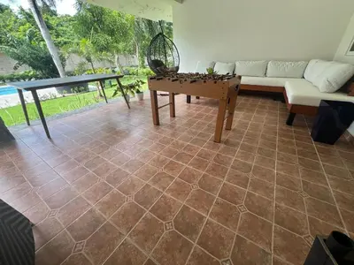 a living room with a table and a couch at Villa Guavaberry in Juan Dolio