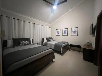 a bedroom with two beds and a ceiling fan at Villa Guavaberry in Juan Dolio