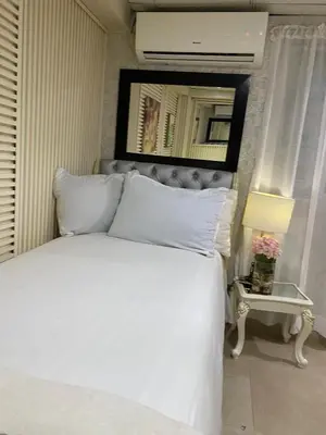 a bedroom with a white bed with a mirror above it at Feair in Santo Domingo