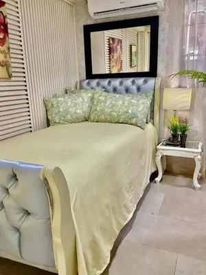 a bedroom with a bed with a white bedspread at Feair in Santo Domingo