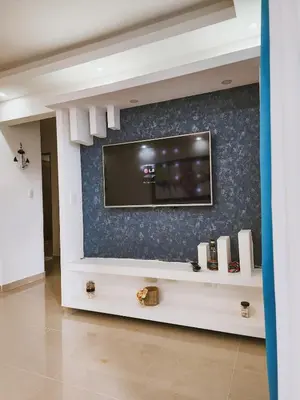 a living room with a flat screen tv on a wall at Cozy apartment Marea Azul in La Francia