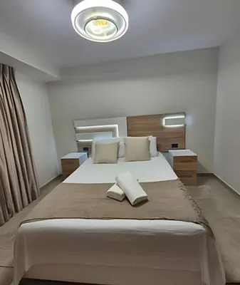 a bedroom with a large bed with two pillows on it at LD House Luxury Próximo embajada EEUU in Jacagua