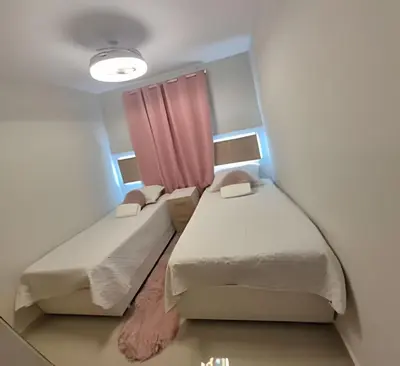 a room with two beds and a pink curtain at LD House Luxury Próximo embajada EEUU in Jacagua