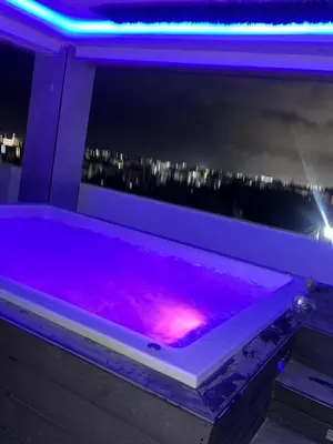 a purple bath tub with a city in the background at Apartamento Santo Domingo este in Juan López