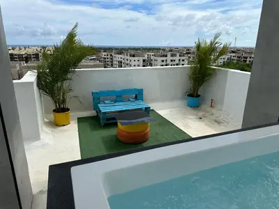 a balcony with a hot tub and a table and chairs at Apartamento Santo Domingo este in Juan López