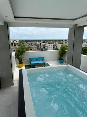a swimming pool on the roof of a building at Apartamento Santo Domingo este in Juan López
