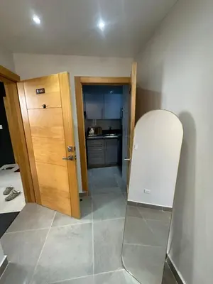 a room with a door and a white refrigerator at Apartamento Santo Domingo este in Juan López