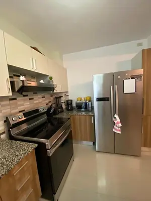 a kitchen with a stainless steel refrigerator with a note on it at Cozy retreat with luxurious feel in Santiago de los Caballeros