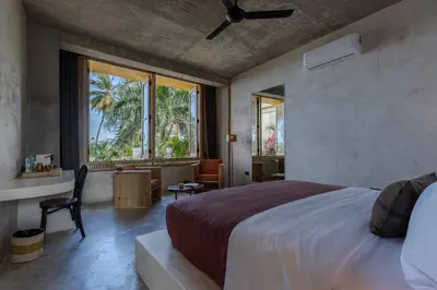 a bedroom with a large bed and a large window at El Mambo Boutique Hotel in Las Terrenas