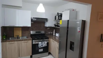 a kitchen with a refrigerator and a stove at Beautiful Accommodation in La Romana Beach View in La Romana