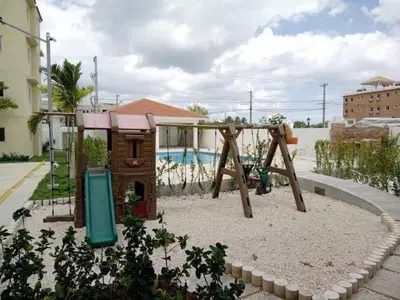 a playground with a swing set in a yard at Beautiful Accommodation in La Romana Beach View in La Romana