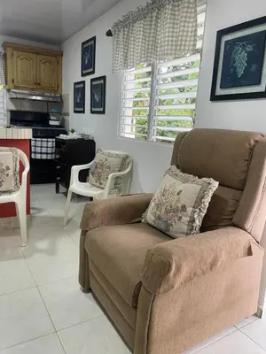 a living room with a couch and a kitchen at Nancy house in Monción