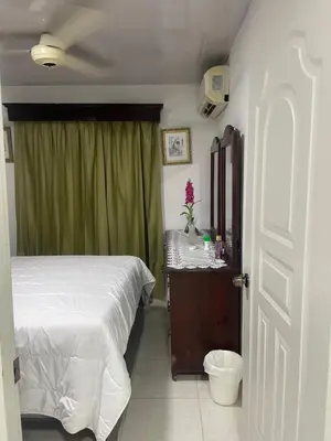 a bedroom with a bed and a green curtain at Nancy house in Monción