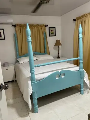 a bed with a blue frame in a bedroom at Nancy house in Monción