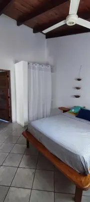a bedroom with a bed and a ceiling fan at MOREHomes - Caribe Slow Cost in Las Galeras