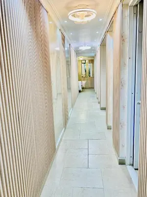 a corridor of an office building with a tile hallway at Jacqueline in Santo Domingo