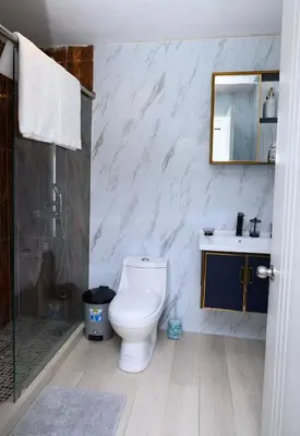 a bathroom with a toilet and a shower and a sink at villas ecologicas hacienda vista linda in Cabrera