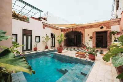 a house with a swimming pool in a courtyard at Casa Grullon, an Oasis in the Colonial Zone in Santo Domingo