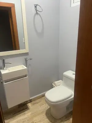 a bathroom with a toilet and a sink and a mirror at Laguna beach in Sosúa