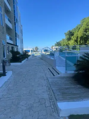 an empty sidewalk in front of a building at Laguna beach in Sosúa