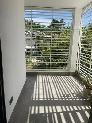a room with a large window with blinds on it at Appartement cosy avec terrasse in Santa Bárbara de Samaná