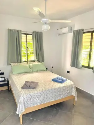 a bedroom with a bed with two towels on it at Appartement cosy avec terrasse in Santa Bárbara de Samaná