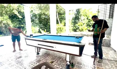 two men playing pool with a pool table at Double P Ranch 20 guests, BBQ and pool Buggy rental in Pedro Brand