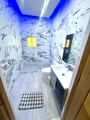 a bathroom with a marble wall with a toilet and a sink at Double P Ranch 20 guests, BBQ and pool Buggy rental in Pedro Brand