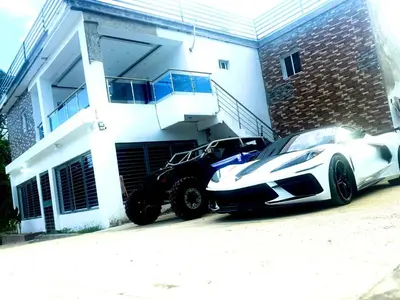 a black and white car parked in front of a house at Double P Ranch 20 guests, BBQ and pool Buggy rental in Pedro Brand