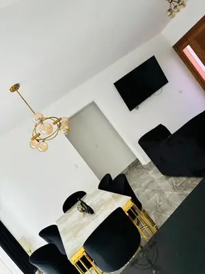 a room with a table and chairs and a television at El Rincón Soleado 1 in San Felipe de Puerto Plata