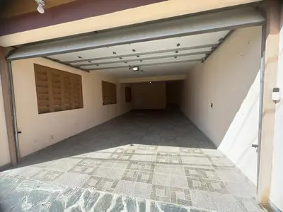 an empty garage with a door and a tile floor at Villa Barias in Las Calderas