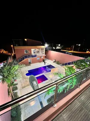 a view of a swimming pool on a balcony at night at Villa Barias in Las Calderas