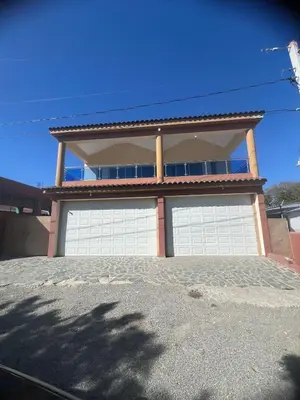 a house with two garage doors in front of it at Villa Barias in Las Calderas