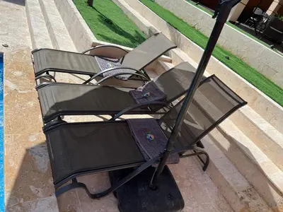 a couple of chairs sitting next to a pool at Villa Barias in Las Calderas