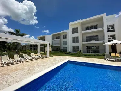 a swimming pool in front of a building at Las Cañas Playa Nueva Romana in El Soco