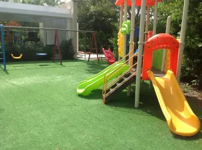 a playground with a slide in a yard at Las Cañas Playa Nueva Romana in El Soco