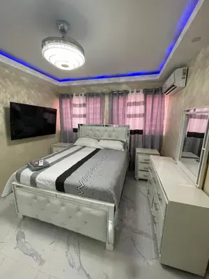 a bedroom with a large bed and a tv at Apartamento in Cancino