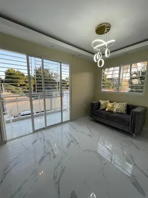 a living room with a marble floor and a couch at Apartamento in Cancino