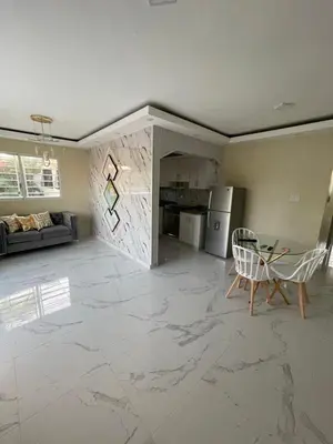 a living room with a marble floor and a table and chairs at Apartamento in Cancino
