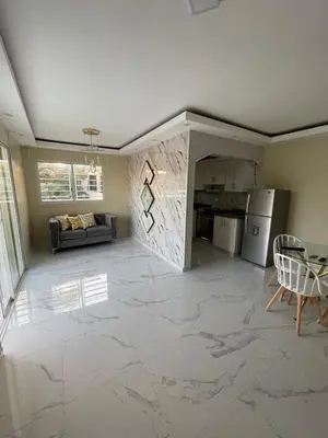 a living room with a marble floor and a kitchen at Apartamento in Cancino