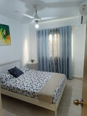 a bedroom with a bed and a ceiling fan at Apartment in Riviera Colonial in Calero